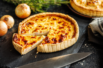 Traditional french pie. Quiche lorraine on kitchen table.