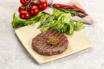 Frilled beef burger cutlet with iceberg