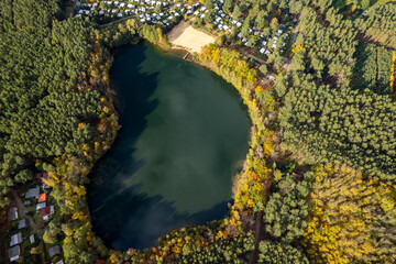 Aerial shot of beautiful lake surrounded by forest in a calm autumn day. Germany. - 751317888