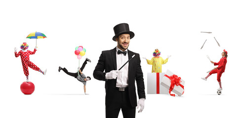 Magician with a wand, mime and clowns performing in the back isolated on white background