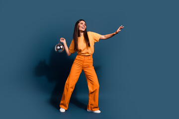 Full length photo of brunette charming model girl with disco ball makes rhythm dynamic dance moves...