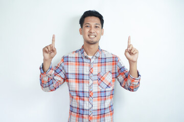 Adult Asian man smiling happy and pointing both hands up