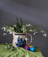 A still life arrangement of Easter eggs, spring flowers. Still life with snowdrops and ester eags. - 751330056