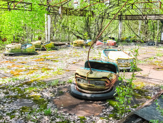 Pripyat, an abandoned playground with cars.
