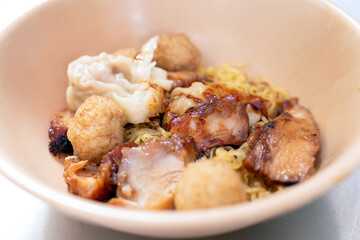 Egg chinese noodles and dumpling with roast red pork and shimp ball.