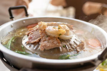 Grill barbecue on pan and hot pot street buffet thai style. (Moo Kra Ta)