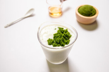 Healthy smoothie with greek yogurt and wolffia globosa in glass isolated on white table background. Wolffia globosa is the nutrient-rich plant-based source of protein and omega3 and vital minerals.