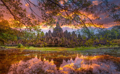 Fototapeta premium Ancient stone faces at sunset of Bayon temple, Angkor Wat, Siem reap, Cambodia.