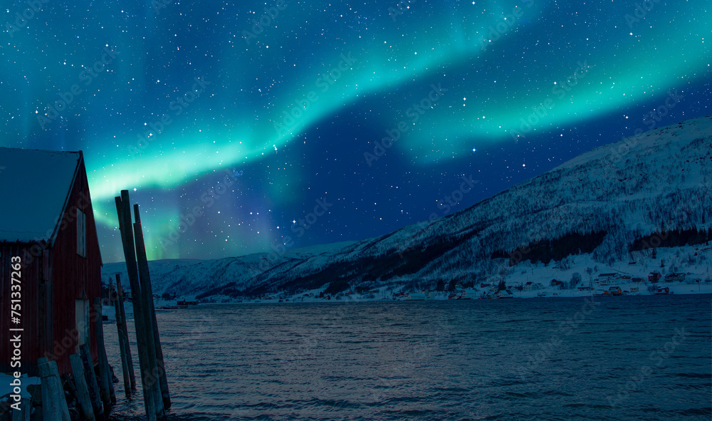 Wall mural red house covered with layers of snow - aurora borealis in tromso, norway in front of the norwegian 
