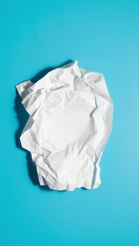 Stop motion animation of crumpled paper on a blue background