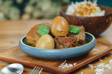 A plate of food with a fork and spoon on a wooden table