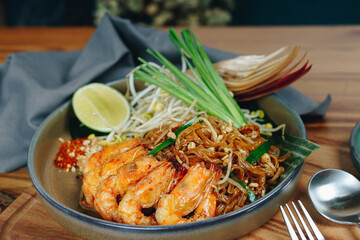 A plate of food with shrimp and lime on top