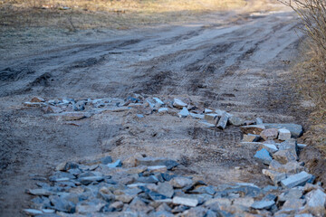 granite chips on muddy dirt road