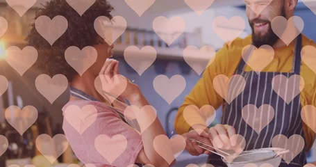 Zelfklevend Fotobehang Image of hearts over diverse couple preparing meal in kitchen © vectorfusionart