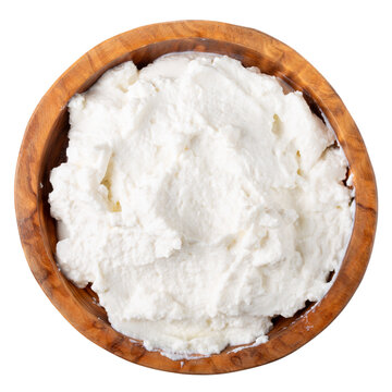 Soft cheese in wooden bowl isolated on white.  Ricotta cheese. Top view.