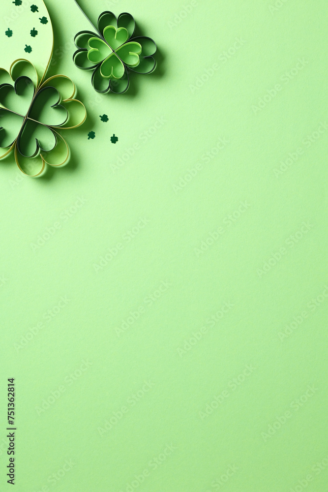 Wall mural St Patricks Day vertical banner design with paper cut four leaf clover and confetti on green background.