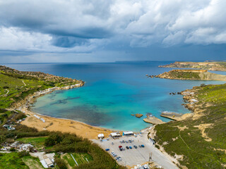 Aerial view of Gnejna Bay and sea, stormy winter sky. Malta country