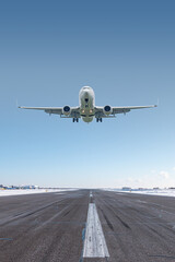 White passenger jet plane take off airport runway at winter