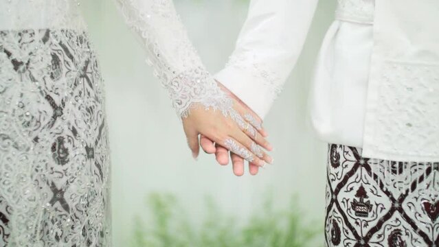 bride and groom holding hands