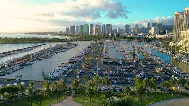 Ala Wai Yacht Harbor sunset flyover towards Ala Moana with Ward Village and Kakaako in the distance.