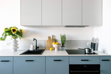 Close up of simple interior design in kitchen with appliances and bright modern furniture