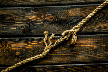 risk concept with rope near to break on wooden background top view space for text