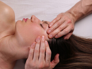 Beautiful Woman enjoying Myofascial face massage Antiaging concept, Holistic wellness