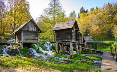 Old small wooden water mills called Mlincici built on Pliva lake near Jajce, Bosnia and Herzegovina.