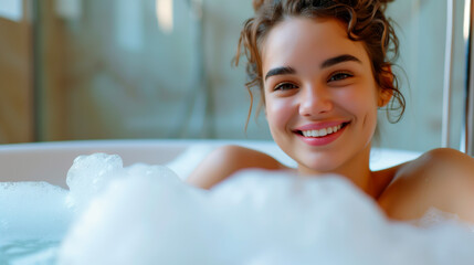 Woman enjoying a relaxing bubble bath at home, surrounded by soap suds and warmth.
 - obrazy, fototapety, plakaty