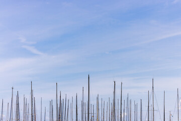 Tops of boat masts against the blue sky