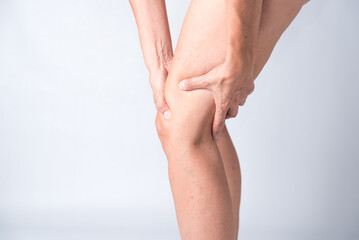 A person with a knee injury is holding their knee. Concept of pain and discomfort