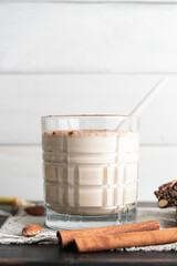 Glass with protein drink, healthy milkshake smoothie on wooden board