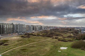 a panorama of the coastline of the apartments along the North Sea in Middelkerke Belgium and a beautiful view of the dunes and nature reserve for walking together with beautiful weather conditions