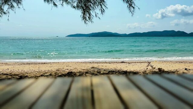 Picnic wooden table with tropical beach blue sea view of Thailand.