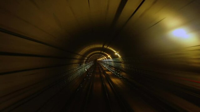 Subway train moving forward in tunnel with orange light. 3d rendering seamless loop motion graphic.
