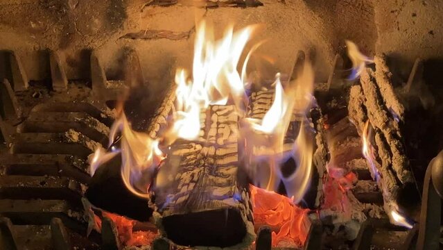 Open log fire in old iron  fireplace 