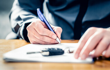 Car lease loan document. Auto finance or insurance paperwork. Sell, rent or buy used vehicle. Dealership company or rental agency contract policy. Credit application form. Man signing agreement. - obrazy, fototapety, plakaty