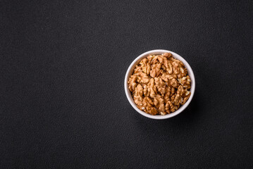 Delicious fresh peeled raw walnuts in a ceramic plate