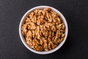Delicious fresh peeled raw walnuts in a ceramic plate
