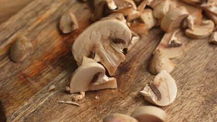 Slicing Mushroom on Wooden Board. High angle view, shallow dof.