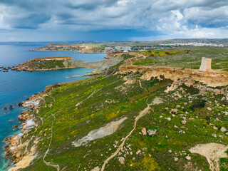 Drone aerial view of Maltese nature landscape and tower, stormy sky. Malta 