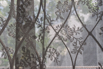 see through transparent curtains and curved steel of a window