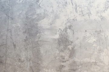 Grungy grey concrete wall with plaster.