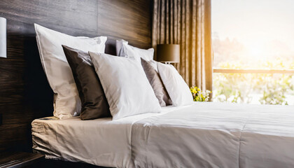 Fototapety  Bed maid-up with clean white pillows and bed sheets in beauty room. Close-up. Lens flair in sunlight,image