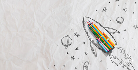 Back to school theme with hand drawn rocket and colored pencils - crumpled paper background - 751415661