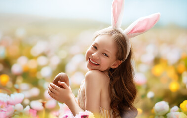 child with choco egg outdoors - 751420231