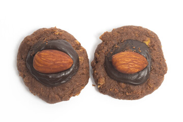 Two afghan cookies made from chocolate and cornflakes with almond on top view isolated on white...