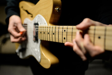 Fototapeta na wymiar Hands playing a guitar - close up