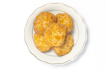 Cornflakes cookies in a small white plate top view isolated on white background clipping path