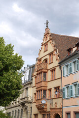 View of one street of the city of Colmar with the medieval house Maison des Tetes, France